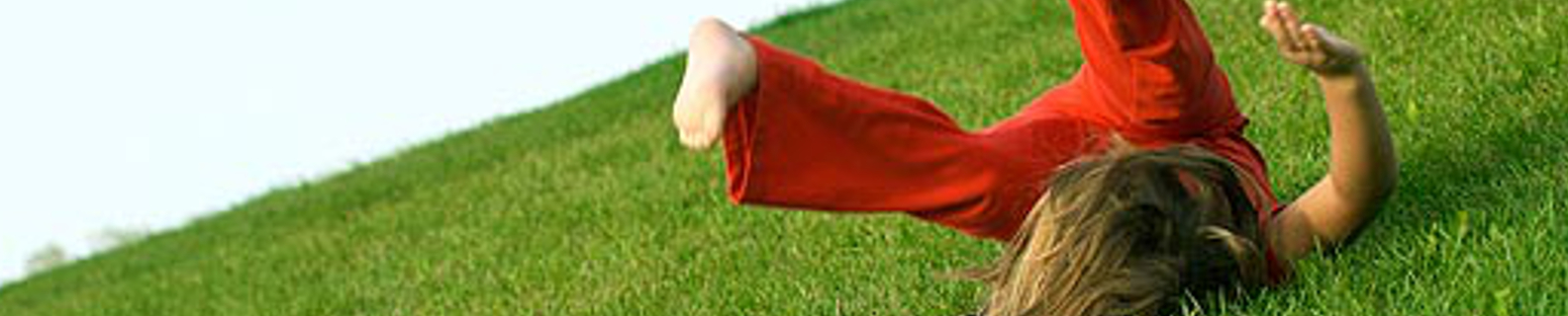 girl rolling down a hill